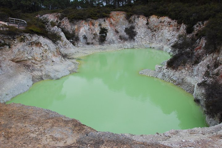 Explore the unique sights of Waiotapu where the vibrant green geothermal pools create a surreal landscape perfect for memorable moments with family and friends in Rotorua.